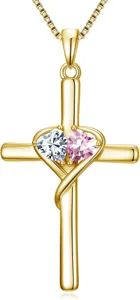 Close-up detail of the gold cross pendant necklace featuring dual sparkling heart stones.