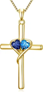 Close-up detail of the elegant gold cross double heart blue gemstone pendant necklace.