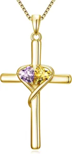 Detailed close-up of gold cross pendant necklace featuring sparkling purple and yellow heart stones.