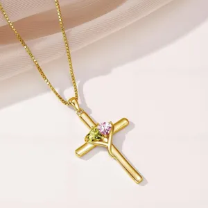 Elegant gold cross necklace for women with sparkling green and pink heart crystal pendants.