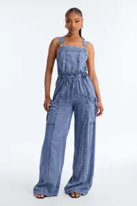 Detailed view of the stylish blue denim bib utility jumpsuit featuring wide-leg design.