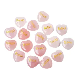Natural rose quartz heart crystal stones with engraved inspirational words, healing decor.