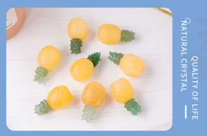 Detailed view of natural crystal and aventurine stone pineapple carving desktop decor.