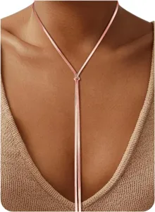 Close-up of elegant rose gold lariat snake chain necklace detail on model, chic and stylish.