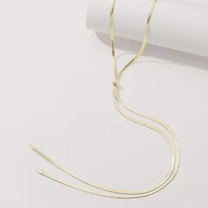 Gold snake chain Y-shaped necklace detail shot, minimalist design with adjustable slider.