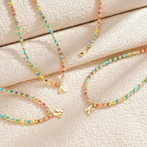 Colorful beaded initial necklace with gold letter pendant, rainbow fashion jewelry for women.