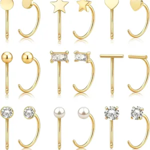 Lot de piercings de nez dorés avec diverses formes comme étoile, cœur, zircon et perle.