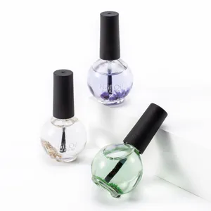 Close-up detail of 15ml nail care oil bottles featuring natural dried flowers inside, clear glass.