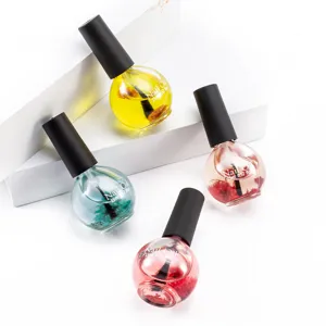 Detailed view of 15ml nail oil bottles with natural dried flowers, moisturizing nail care.
