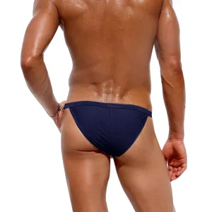 Back view detail of men solid color dark blue swim briefs, comfortable elastic fabric fit.