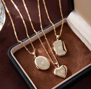 Gold plated openable locket pendant necklace with sparkling cubic zirconia flower detail.