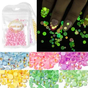 Colorful nail art rhinestones set, glowing crystals and flatback gems for DIY manicure.
