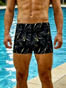 Detailed view of men's geometric print swim trunks, stylish black and yellow pattern.