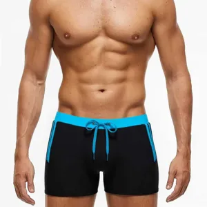 Close-up detail of men's swimming trunks featuring contrast blue waistband and drawstring.