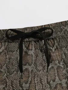Gold metallic hot stamping swim briefs detail, black adjustable drawstring waist design.