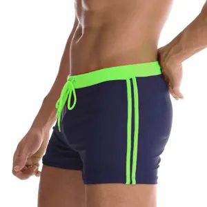 Men's stylish square leg swim trunks with neon green drawstring and side stripe details.