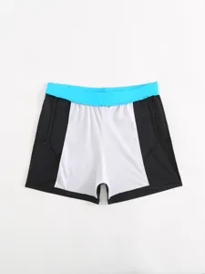 Detail view of men's colorblock swim trunks with blue waistband and contrast side panels.