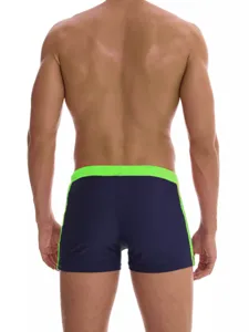 Men's solid color square leg swim trunks featuring a contrast neon green waistband.