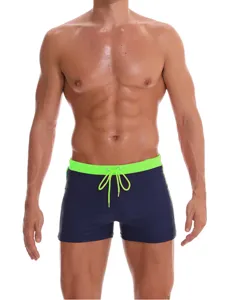 Detail view of men's swim trunks with contrast neon green waistband and drawstring.