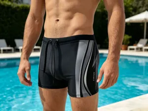 Detail view of men's athletic swim trunks featuring stylish side stripes and a secure drawstring waist.