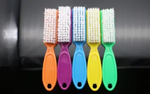 Colorful plastic nail cleaning brushes with white hard bristles, 5 pack detail view.