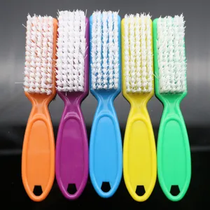 Colorful plastic nail cleaning brush with hard white bristles for manicure dust removal.