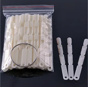 Gedetailleerd overzicht van witte plastic nagel display sticks met een metalen ring.