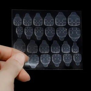 Clear double-sided nail jelly glue tabs, transparent adhesive sticker for fake nails detail.