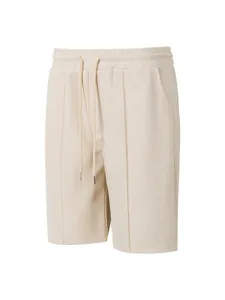 Detail view of men's beige waffle knit casual shorts with drawstring waist and comfortable fit.