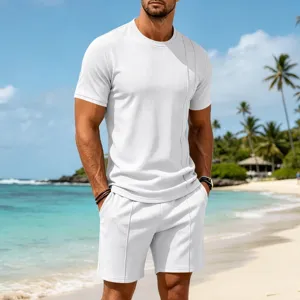 Detailed shot of men's casual white waffle knit short sleeve and shorts set on tropical beach.