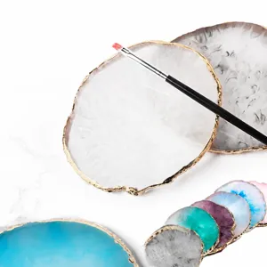 Resin agate nail art palette with luxury gold rim and brush for professional gel polish color mixing.
