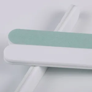 Professional dual-sided nail file and buffer block for manicure and nail shaping care detail.