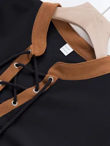 Detail view of waffle knit long sleeve shirt collar with lace-up design and contrast color.