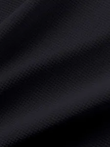 Waffle knit fabric detail view showcasing soft texture, breathable weave and black color.