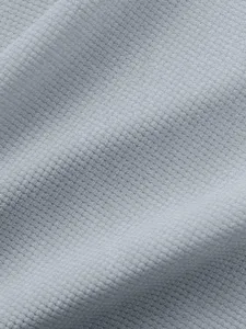 Light grey waffle knit fabric detail, soft texture and breathable material close up view.