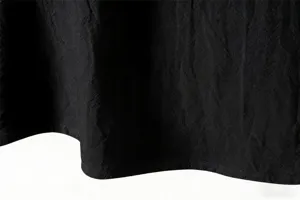 Detailed view of the black fabric texture and neat stitching of the casual shirt.