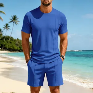 Blue waffle knit short sleeve t-shirt and shorts set worn by model on beach scene.