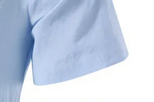 Close-up detail of the light blue men's casual short sleeve shirt fabric and sleeve cuff.