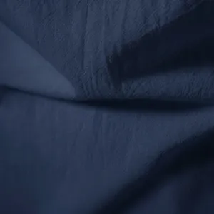 Dark blue fabric texture detail close-up shot of men's casual retro short sleeve shirt.