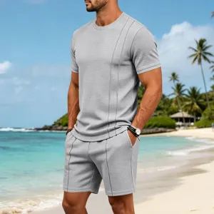 Detailed view of casual men's waffle knit short sleeve top and shorts set on beach scene.