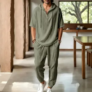 Relaxed fit linen blend two piece set featuring hooded short sleeve shirt and lounge pants.