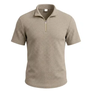 Close-up detail of the waffle textured knit fabric, half-zip collar, short sleeve polo shirt.