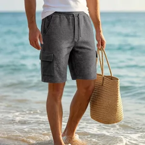 Detailed view of men's grey grid cargo shorts featuring side utility pockets and comfortable waist.