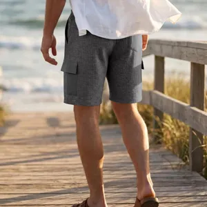 Men's casual cargo shorts detail view, grey waffle textured outdoor summer beach wear.