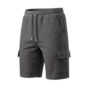 Mens dark grey waffle knit cargo shorts with elastic drawstring and multiple utility pockets.