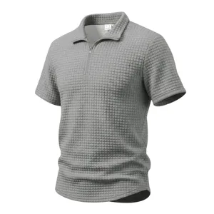 Grey waffle knit textured fabric detail view showcasing the short sleeve zipper polo shirt.
