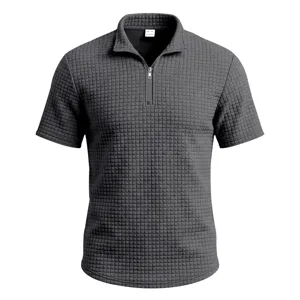 Close-up view of the dark grey waffle-knit texture and half-zipper stand collar detail.