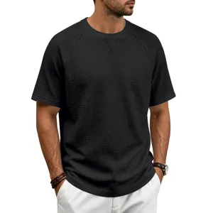 Close-up detail of men's casual black waffle knit short sleeve t-shirt fabric texture.
