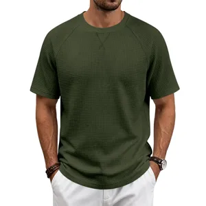 Close up of waffle knit fabric detail and crewneck design on green men short sleeve t-shirt.