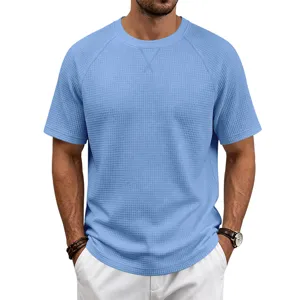 Light blue waffle knit fabric detail of men casual short sleeve t-shirt close up.